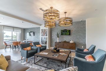 Orange City apartment for rent - a living room with couches and chairs and a table
