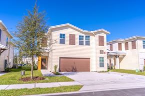 Mount Dora apartment for rent - A house with a brown garage door is surrounded by other similar houses.