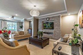 Winter Park apartment for rent - Clubhouse room with a stone fireplace and a television above it.