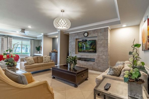 Winter Park apartment for rent - Clubhouse room with a stone fireplace and a television above it.