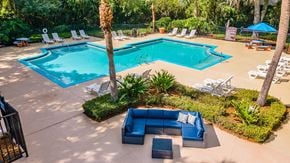 Winter Garden apartment for rent - A pool area with a blue couch and chairs.