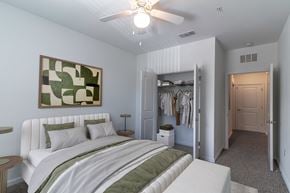 Lady Lake apartment for rent - A bedroom with a large bed and a painting on the wall.