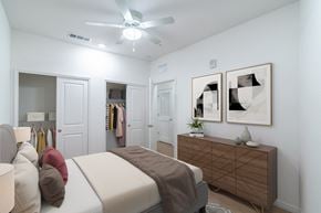 Mount Dora apartment for rent - A bedroom with a bed, a dresser, and a ceiling fan.