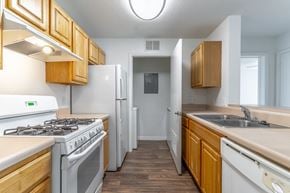 Port St. Lucie apartment for rent - A kitchen with a white stove and white refrigerator.