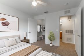 Port St. Lucie apartment for rent - A bedroom with a large bed and a painting on the wall.