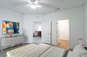 Palm Coast apartment for rent - A bedroom with a bed, dresser, and painting.
