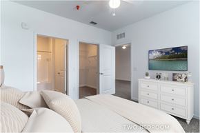 Palm Coast apartment for rent - A bedroom with a bed, dresser, and two doors.