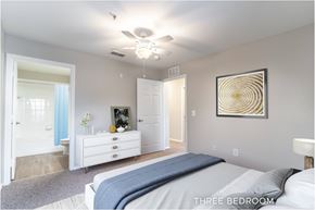 Eustis apartment for rent - A bedroom with a bed, dresser, and ceiling fan.