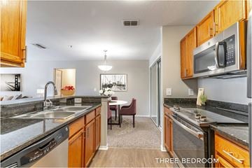 Eustis apartment for rent - A kitchen with a dining table and chairs in the middle of the room.