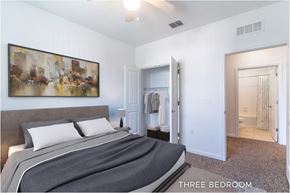 Daytona Beach apartment for rent - A bedroom with a bed, a painting on the wall, and a mirror.
