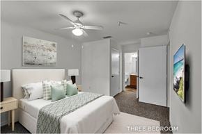 Orlando apartment for rent - A bedroom with a bed, a ceiling fan, and a painting on the wall.