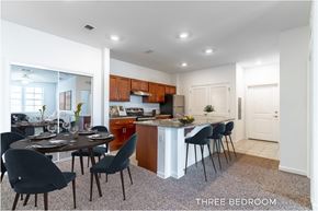 Daytona Beach apartment for rent - A kitchen with a dining table and chairs in a three bedroom apartment.