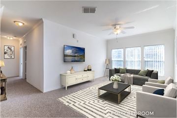 Palm Coast apartment for rent - A living room with a couch, a coffee table, and a painting on the wall.