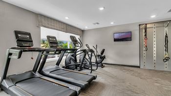 24 Hour fitness and conditioning club w/ state of the art multi-functional training equipment, kettle bells, dumb bells and isa wall for full body conditioning