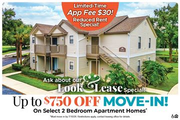 Winter Garden apartment for rent - A large two-story apartment building with a sign offering a limited-time app fee free and a reduced rent special.