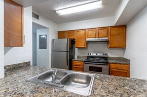 Orlando apartment for rent - a kitchen with granite countertops and stainless steel appliances