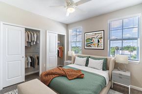 Deland apartment for rent - a bedroom with a bed and a ceiling fan