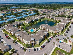 Kissimmee apartment for rent - an aerial view of a community with a large lake in the middle of it