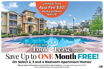 Kissimmee apartment for rent - A large apartment complex with a pool and a sign offering a free month if you sign up for a lease.