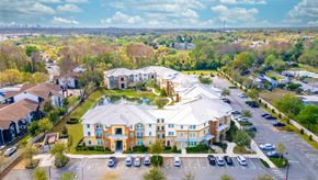 Winter Park apartment for rent - an aerial view of a large building with a fountain in the middle of a parking lot