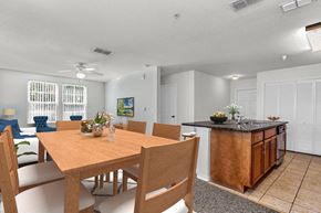 Winter Park apartment for rent - a dining area with a wooden table and chairs and a kitchen with a black counter top and