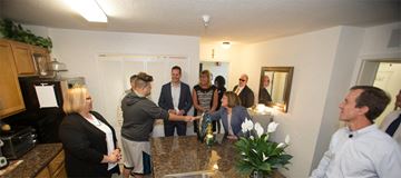Orlando apartment for rent - a group of people standing in a kitchen and shaking hands