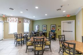 Port St. Lucie apartment for rent - a seating area with tables and chairs at the whispering winds apartments in pearland