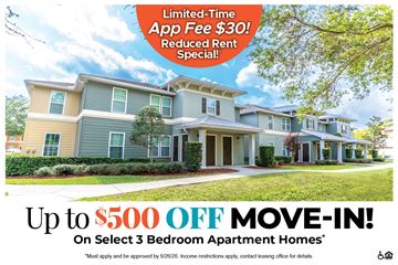 Rockledge apartment for rent - A large, multi-story apartment building with a lawn in front and a tree to the left.
