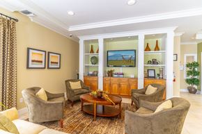 Rockledge apartment for rent - a clubhouse filled with furniture and a flat screen tv