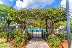 Rockledge apartment for rent - a pergola with a walkway leading to a pool
