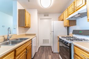 Tampa apartment for rent - a kitchen with wood cabinets and white appliances