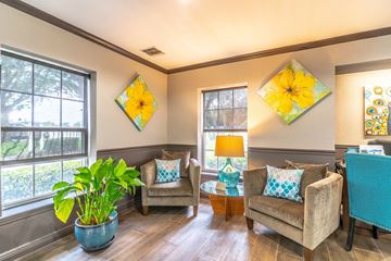 Brandon apartment for rent - a living room with couches and chairs and a table