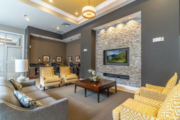 Orlando apartment for rent - a living room with couches and chairs and a fireplace
