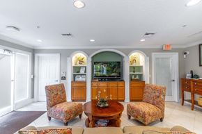 Oviedo apartment for rent - a living room with couches and a table and a television
