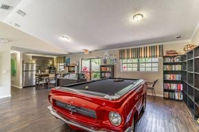 New Port Richey apartment for rent - a game room with a pool table and bookshelves