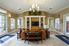 Leesburg townhouse for rent - a large living room with a large tv on the wall and a large wooden table in the