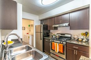 Oviedo apartment for rent - a kitchen with brown cabinets and stainless steel appliances