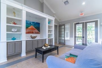 Sarasota apartment for rent - a living room with a blue couch and a coffee table