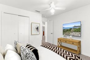 Sarasota apartment for rent - a bedroom with a large bed and a ceiling fan
