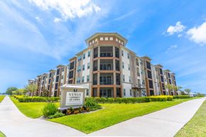 Viera apartment for rent - a large apartment building with a sidewalk in front of it