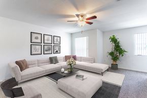 Orlando apartment for rent - a living room with white walls and a ceiling fan