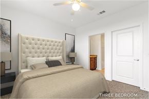 Orlando apartment for rent - A bedroom with a large bed and a ceiling fan.