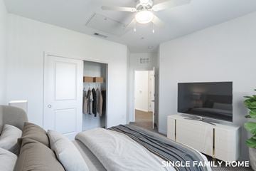 Mount Dora apartment for rent - A living room with a grey couch and a television on a cabinet.