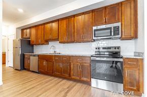 Mount Dora apartment for rent - A kitchen with wooden cabinets and stainless steel appliances.