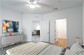 Palm Coast apartment for rent - A bedroom with a bed, dresser, and painting.