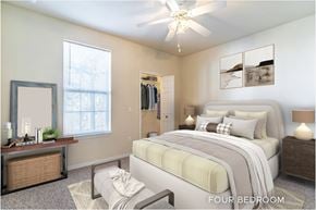 Orlando apartment for rent - A bedroom with a large bed and a ceiling fan.