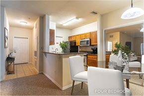 Orlando apartment for rent - A kitchen with a dining table and chairs in a four bedroom apartment.