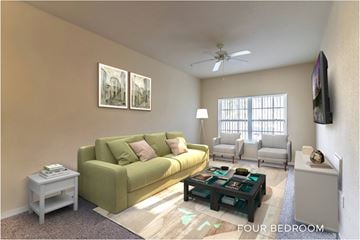 Orlando apartment for rent - A living room with a green couch and a flat screen TV mounted on the wall.