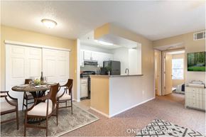Winter Garden apartment for rent - A kitchen with a dining table and chairs in the middle of the room.