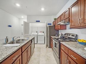 Lady Lake apartment for rent - a kitchen with wooden cabinets and granite counter tops